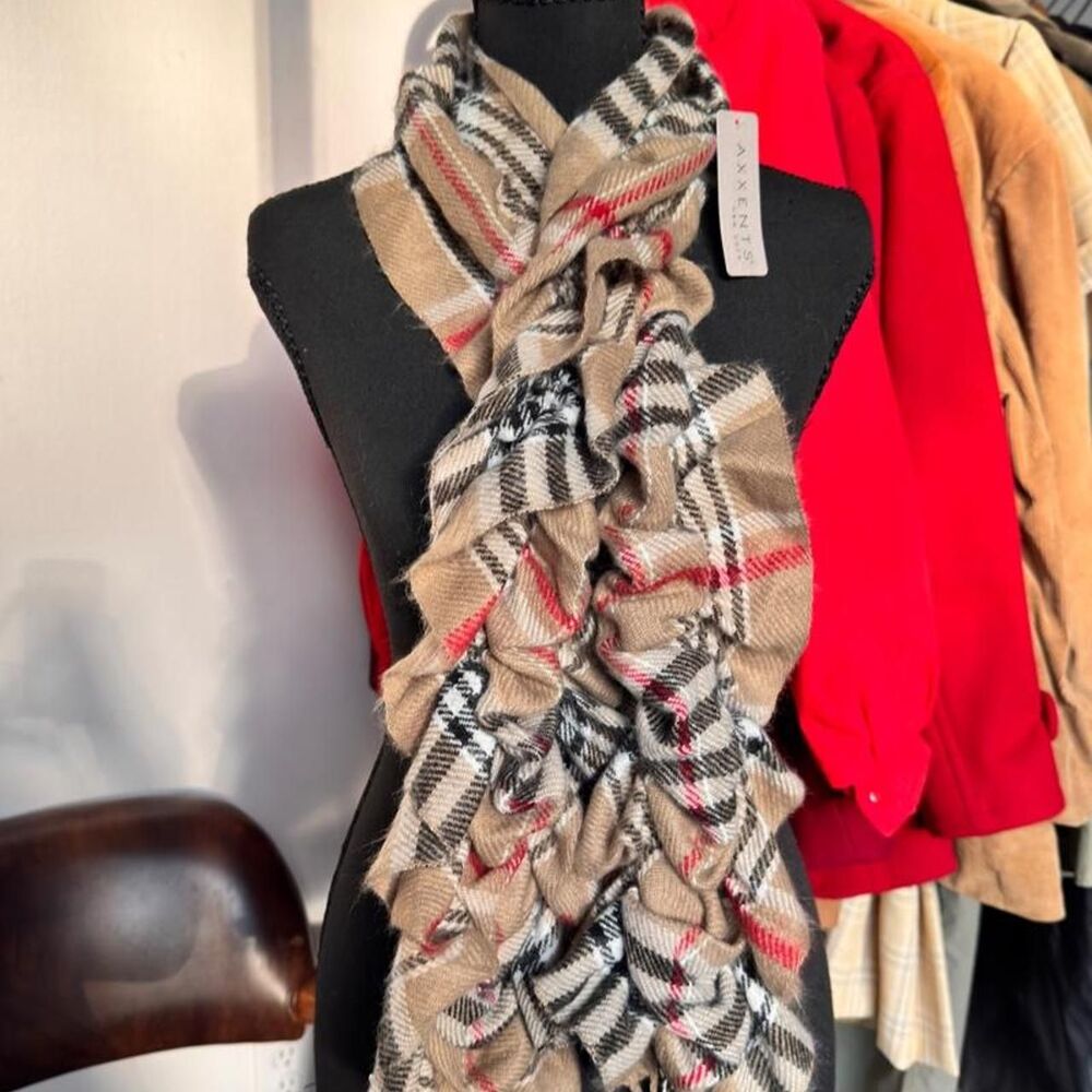 Black, beige, and red plaid scarf with ruffles and fringe